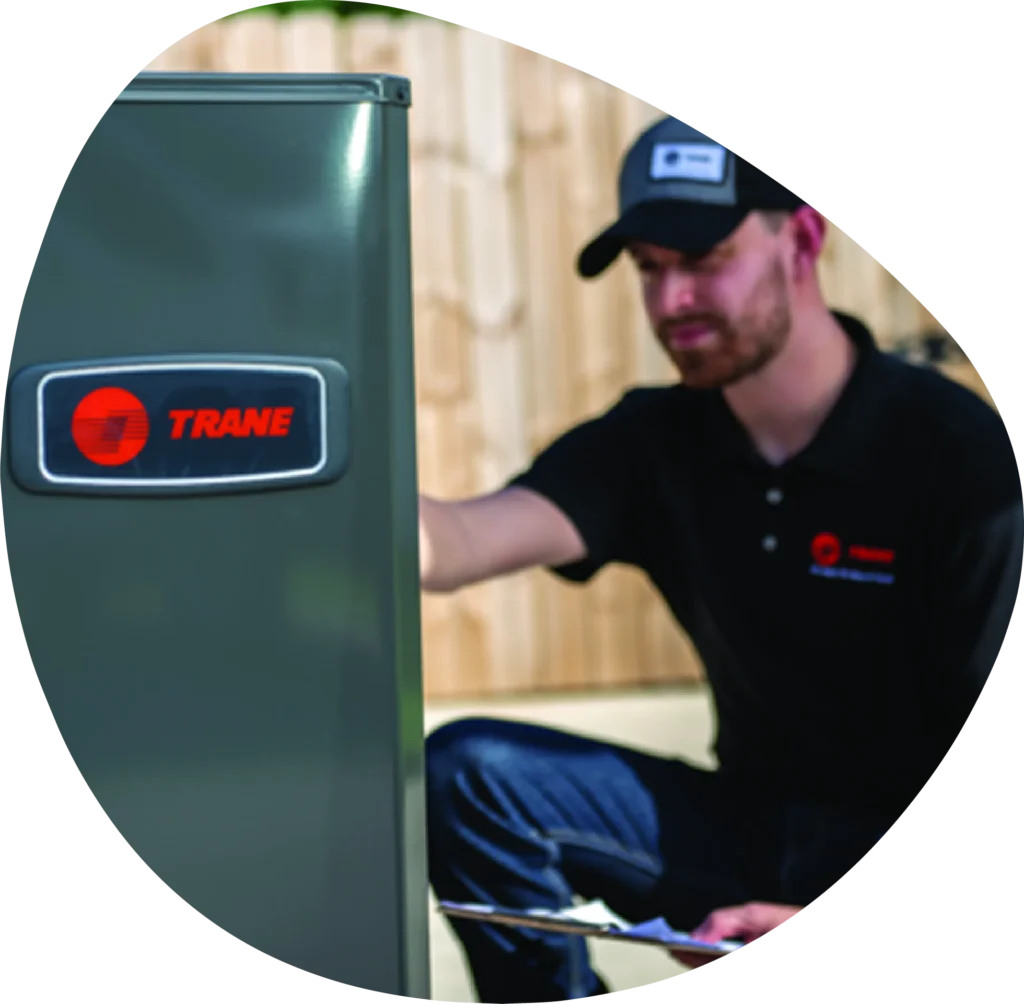 Expert HVAC technician servicing a Trane unit during an HVAC installation in Seattle.